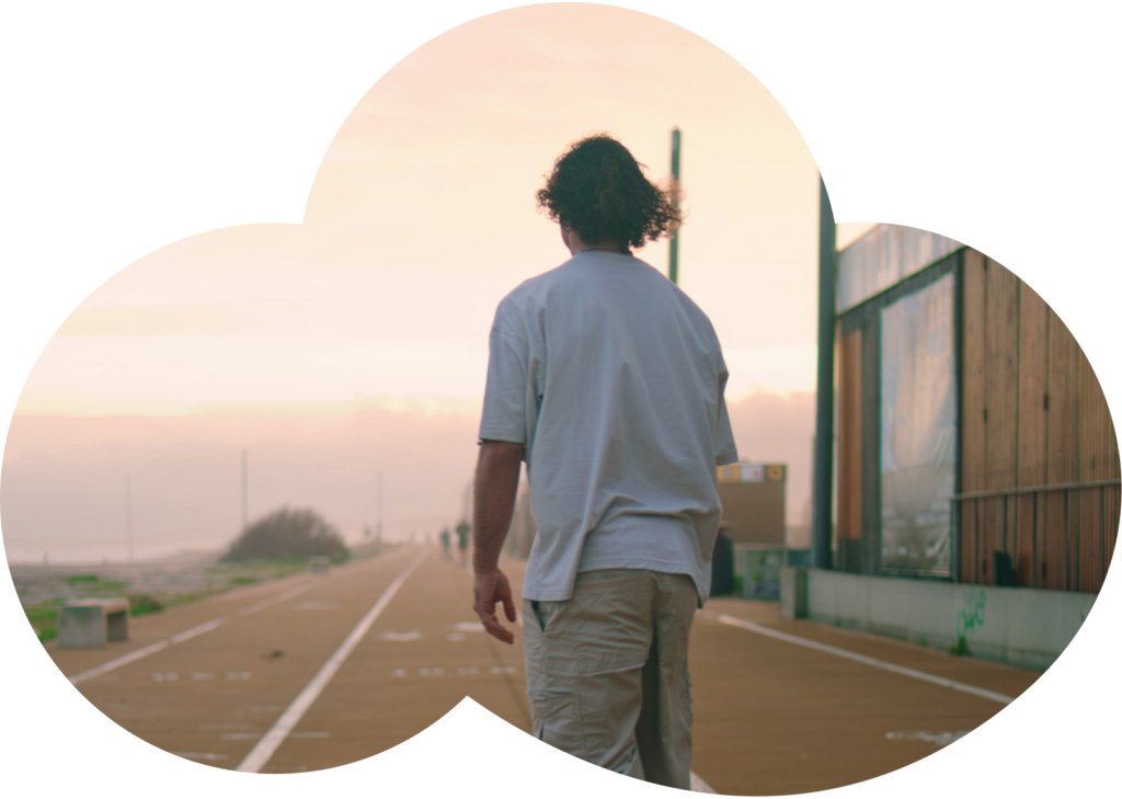 Person walking along a seaside path at sunrise