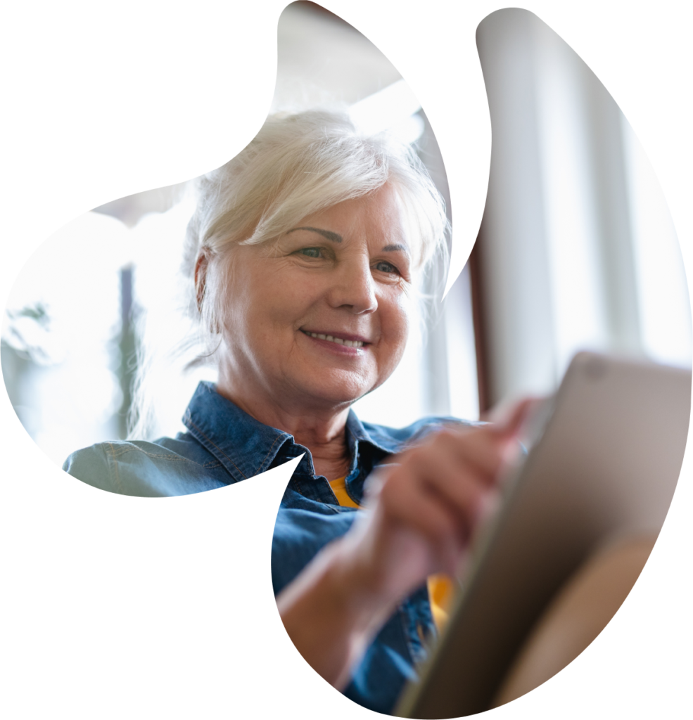 Smiling woman using a tablet at home